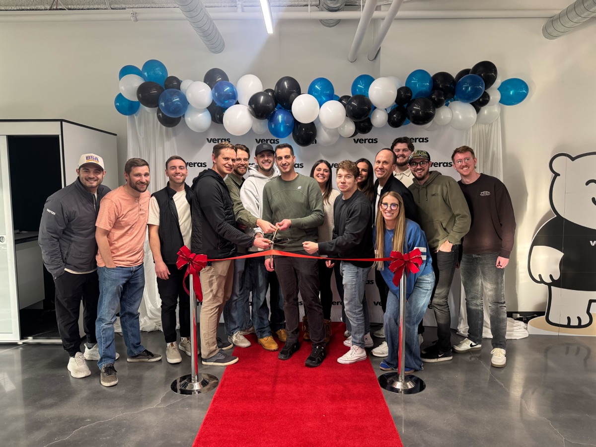 Office ribbon cutting with the full team